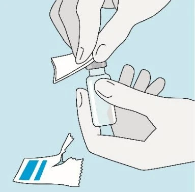 Two hands opening a glass vial with a protective cap on a blue background next to an open white and blue paper wrapper