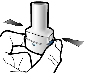 A hand holding a white medical device and pressing the central part with fingers moving inward