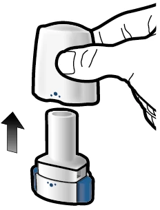 A hand lifting a white cap off a cylindrical medical device with a blue base and small dark spots indicated by an arrow pointing downward