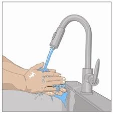 Two hands being washed under a stream of water