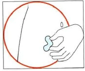 A hand grasping a small portion of skin tissue by pinching it between the fingers
