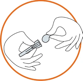 Two hands pouring a gray pill from an open cylindrical container