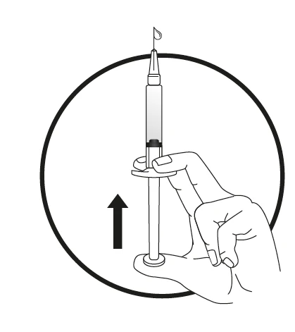 A hand holding a syringe vertically with a