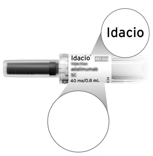 Close-up detail of a single-use syringe of Idacio 40 mg in 0.8 ml with white label and black text on light background