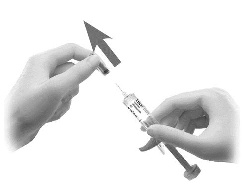 Two hands separating a protective cap from a syringe with needle and liquid, with an arrow indicating movement away from the