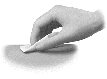 A hand gently applying an adhesive patch or dressing onto a flat, smooth skin surface