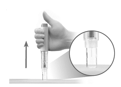 A hand holding a cylindrical medical device with an arrow pointing toward the
