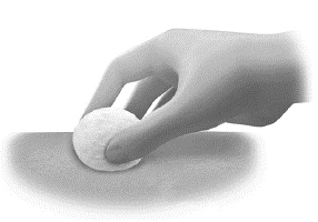 A hand holding a white cotton disk and gently pressing it onto a light skin surface