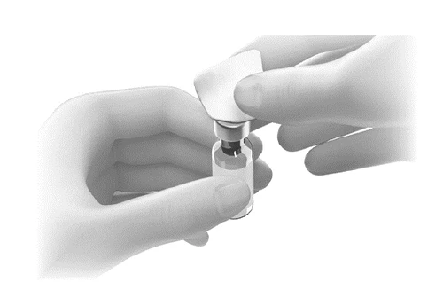 Two hands holding a small glass vial while one hand lifts the transparent protective cap from the rubber stopper of the container