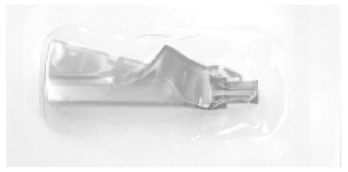 A transparent medical device with elongated and contoured shape inserted in a white protective plastic blister