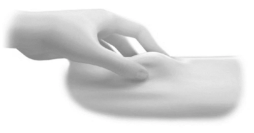A hand pinching and lifting a skin fold to prepare the area for