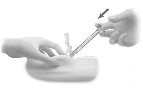 A hand holding a prefilled syringe and placing it on the skin while the