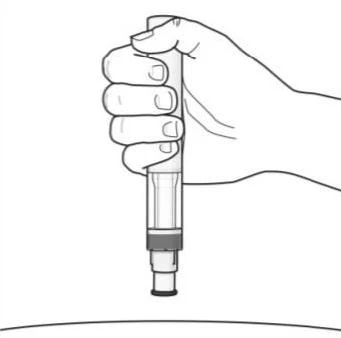A hand holding an injection pen vertically, ready for use