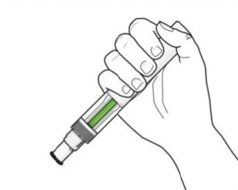 A hand firmly gripping a medical injection pen with a reservoir containing green liquid on a white background