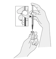A hand holding a vial while the