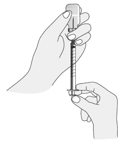 Two hands holding a vertical syringe with a graduated scale to adjust the dosage of liquid contained in the transparent cylinder