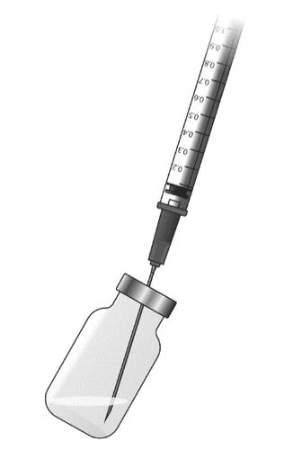 Graduated syringe with needle inserted into the