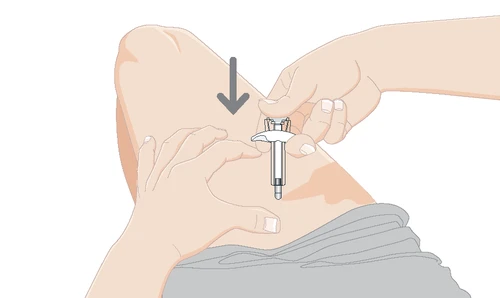 Two hands holding a white and gray cylindrical medical device against the skin of the