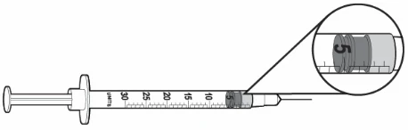 Disegno tecnico di una siringa con scala graduata in unità che mostra un ingrandimento del pistone posizionato sul segno delle 5 unità