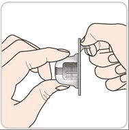 Two hands carefully holding and separating the two components of a transparent and gray plastic medical device on a white background