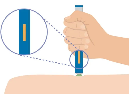 A hand holding a blue and white medical device placed on the arm skin with a close-up showing an orange window