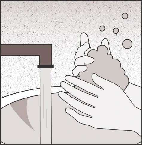 Two hands washing with soap under a running tap with flowing water and soap bubbles