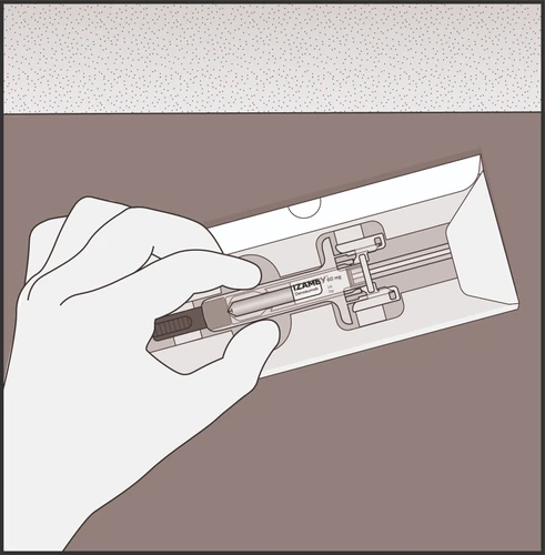 A hand holding a pre-filled syringe labeled Izamy 60 mg removed from a transparent and white plastic package
