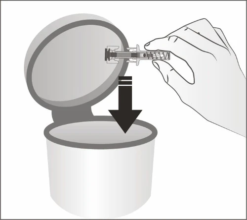 A hand inserting a cylindrical medical device into the