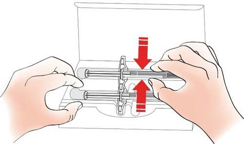 Two hands holding a cylindrical medical device