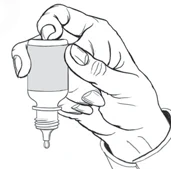 A hand holds a dropper bottle with the cap removed while a drop of liquid is about to fall from the