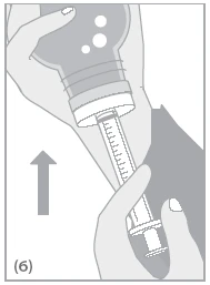 Two hands hold a syringe with a needle inserted into a medicine vial, while an arrow points towards the left