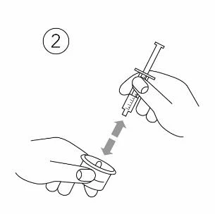 Line drawing showing a hand holding a syringe and the tip of the