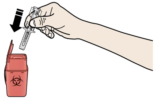 A hand holding a used syringe and inserting it vertically into a red biohazard waste container with a biological hazard symbol
