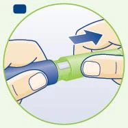 Two hands hold a cylindrical green and blue medical device with a blue arrow indicating a clockwise rotation movement