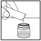A hand pouring powder contents from an open vial into a container