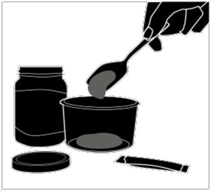 A hand pouring gray contents from a spoon into an open container next to a jar and lid on a white background