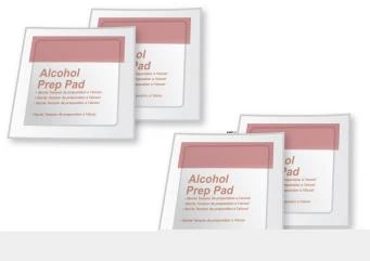 Four square packages of alcohol-impregnated discs labeled Alcohol Prep Pad with white labels and a light pink upper band