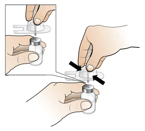 Two hands preparing a medication vial by inserting a syringe