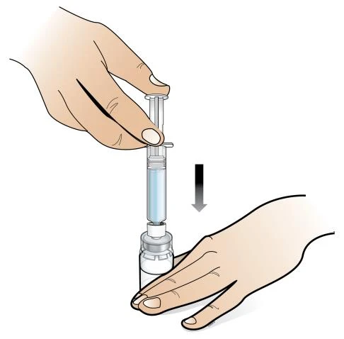 A hand holds a syringe with blue liquid while another hand prepares the injection site