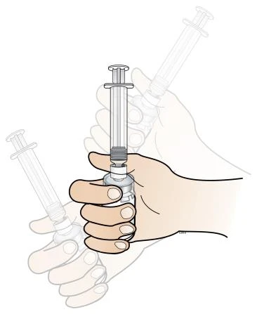 Two hands holding and manipulating two transparent syringes with plungers for preparation or administration