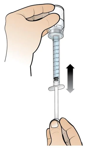 A hand holds the upper part of a syringe while another hand prepares the device