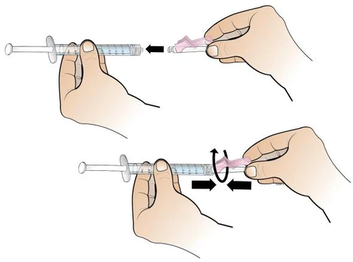 Two hands inserting a pink cap into a transparent syringe and then rotating it to securely fasten it to the device body