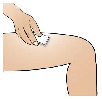 A hand applies a small white adhesive bandage to the upper part of a human thigh with the leg slightly bent