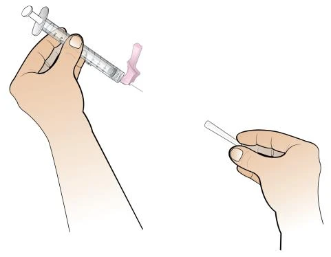 A hand holds a syringe with the needle pointing downward and another hand prepares the injection site