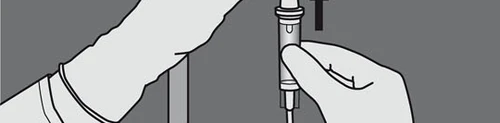 A hand gripping a vertical injection pen while the