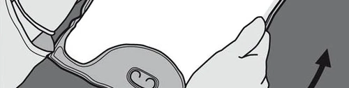 Hands lifting the edge of a flat, circular medical device to reveal its underside with two small central holes