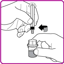 Two hands preparing a medication by inserting the