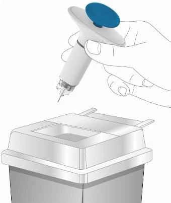 A hand holding a white medical device with a blue button above a disposal container for needles and sharp objects