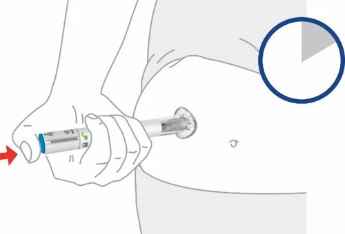 A hand holding a pre-filled syringe to inject medication into the