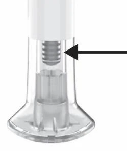 Detail of a transparent medical device with a black arrow indicating an internal cylindrical, grooved component